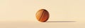 Basketball resting on cream colored surface with matching backdrop Royalty Free Stock Photo