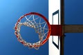 Basketball rim seen from below against clear blue sky Royalty Free Stock Photo