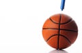 Basketball rubber orange ball inflated by pump on white background Royalty Free Stock Photo