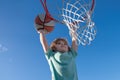 Basketball Slam Dunks of sporty kids basketball player. Close up image of basketball excited kid player dunking the ball Royalty Free Stock Photo