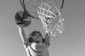 Basketball Slam Dunks of sporty kids basketball player. Close up image of basketball excited kid player dunking the ball Royalty Free Stock Photo