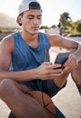 Basketball, sports and man using phone for fitness mobile app, reading online website sport update or internet search