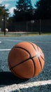 Basketball on sunny outdoor court, ready for game action Royalty Free Stock Photo