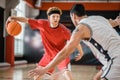 Two young men playing basketball and looking involved Royalty Free Stock Photo