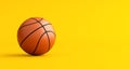 Basketball on yellow background with copy space