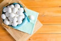 Basketful of fresh white eggs with one outside