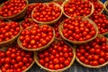 Baskets of cherry tomatoes at a farmers ` market in Oxford in Eng