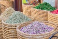 Baskets of colorful natural organic herbal tea in Marrakech market, Morocco. group of beautiful dry colorful flowers. Dried roses