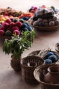 baskets with different types of knitting sit on the ground in front of pots