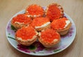 Quick snack. Baskets with red caviar on a saucer/