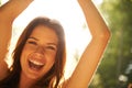 Basking in the bright energy. A beautiful young woman backlit by a bright sun at a music festival. Royalty Free Stock Photo