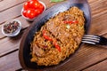 Basmati rice with meat, vegetables and aromatic spices on wooden table. Indian cuisine. Royalty Free Stock Photo