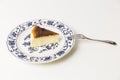 Basque Burnt Cheesecake with fork isolated in white background.