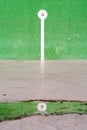 Basque pelota court with number reflection on puddle