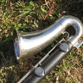 Bass clarinet on grass during marching band practice Royalty Free Stock Photo