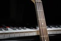 Bass guitar against grand piano keys Royalty Free Stock Photo