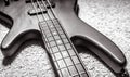 Bass guitar with four strings in black and white closeup. Detail of popular rock musical instrument. Close view of electric bass Royalty Free Stock Photo