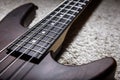 Bass guitar with four strings closeup. Detail of popular rock musical instrument. Close view of brown electric bass, selective Royalty Free Stock Photo