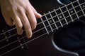 Bass guitar player hand closeup, lesson and practice theme. Playing on bass electric guitar, live music and skill concept Royalty Free Stock Photo