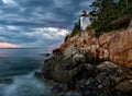 Bass Harbor Lighthouse and stormclouds at dusk Royalty Free Stock Photo