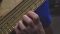 The bass player plays on a five-string bass guitar close-up. Plays bass guitar