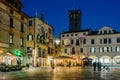 Bassano del Grappa, Italy: People Piazza Libert in cafe tables in the evening in winter. On the left the town hall.