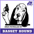 Basset Hound dog with revolver gun - Basset Hound gangster. Head of Funny Basset Hound Royalty Free Stock Photo