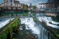 The Bassin L`Isle-sur-la-Sorgue, Vaucluse,.France, with its rivers and waterfalls and bars and restaurants in the background , Royalty Free Stock Photo