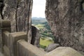 The railing of the unique Bastai bridge and the view through the rocks to the village Royalty Free Stock Photo