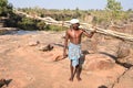 A bastar tribal man carrying woods and axe