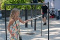 In Bastejkalns Park, Riga, Latvia, a little girl plays a musical instrument Royalty Free Stock Photo