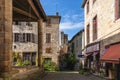 Old street in the medieval village of Cordes sur Ciel in autumn, in the Tarn, Occitanie, France Royalty Free Stock Photo