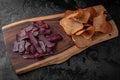 Smoked pork ears with salty dry rye bread. Royalty Free Stock Photo