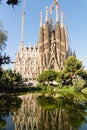 Sagrada Familia with its reflection in the PlaÃ§a de GaudÃ­ park lake water, Barcelona, Spain