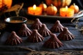 bat-shaped chocolate truffles on an orange silk cloth