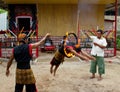 BATAM, INDONESIA - DECEMBER 7, 2012: An Indonesian man jumping through a ring of fire during a local performance