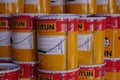 Piles of Jotun brand paint cans.