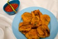 Batata Wada, famous Maharashtrian street food, Potatoes covered with gram flour,
