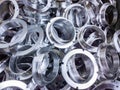 A batch of machined shiny aluminium parts with selective focus