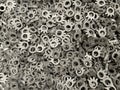 batch of metallic steel parts, mass production of toothed sprockets, lots of steel parts, fine blanking of gear wheels,