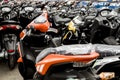 A batch of new Motorcycles parked at a dealership lot.