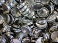 Batch of olod stamped shiny metal caps, selective focus top-down wiew