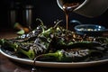 batch of roasted jalapeno peppers drizzled with balsamic glaze