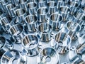 A batch of shiny metal cnc aerospace parts production - close-up with selective focus for industrial background