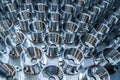 A batch of shiny metal cnc aerospace parts production - close-up with selective focus for industrial background