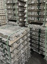 batch of stacked and strapped aluminum ingots, raw material for aluminum die casting, injection molding, raw material warehouse Royalty Free Stock Photo