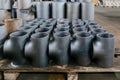 Batch of T shape pipe parts in warehouse