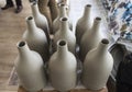 Batch of traditional handmade bottle design from gray colour raw ceramic material after cooked Royalty Free Stock Photo