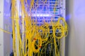 Batch wires are connected in the Optical Fiber Distribution Frame. Messy cables are intertwined in the server room rack. Fiber- Royalty Free Stock Photo