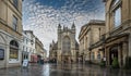 Bath Abbey and The Pump Rooms on a wet day with cloudy blue sky in Bath, Somerset, UK